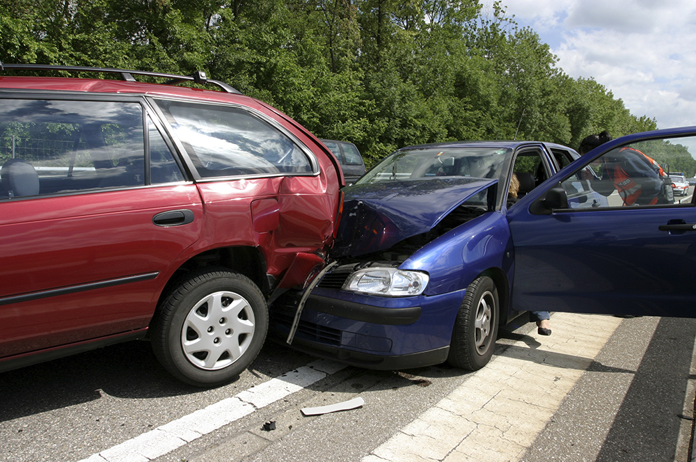 aftermath of a car crash involving a blue and red car